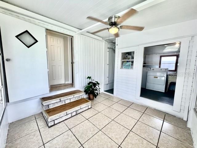 10826 Tioga Drive Port Richey, FL 34668 - Photo 8 of 59 a spacious bedroom with a bed and a chandelier