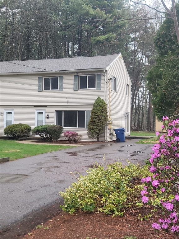 a view of a house with a backyard and a garden