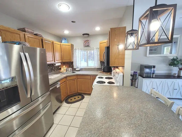 a kitchen with stainless steel appliances a refrigerator and a stove
