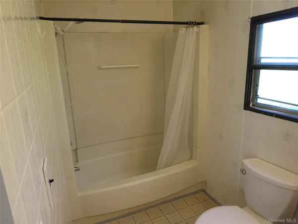 a bathroom with a shower and a toilet