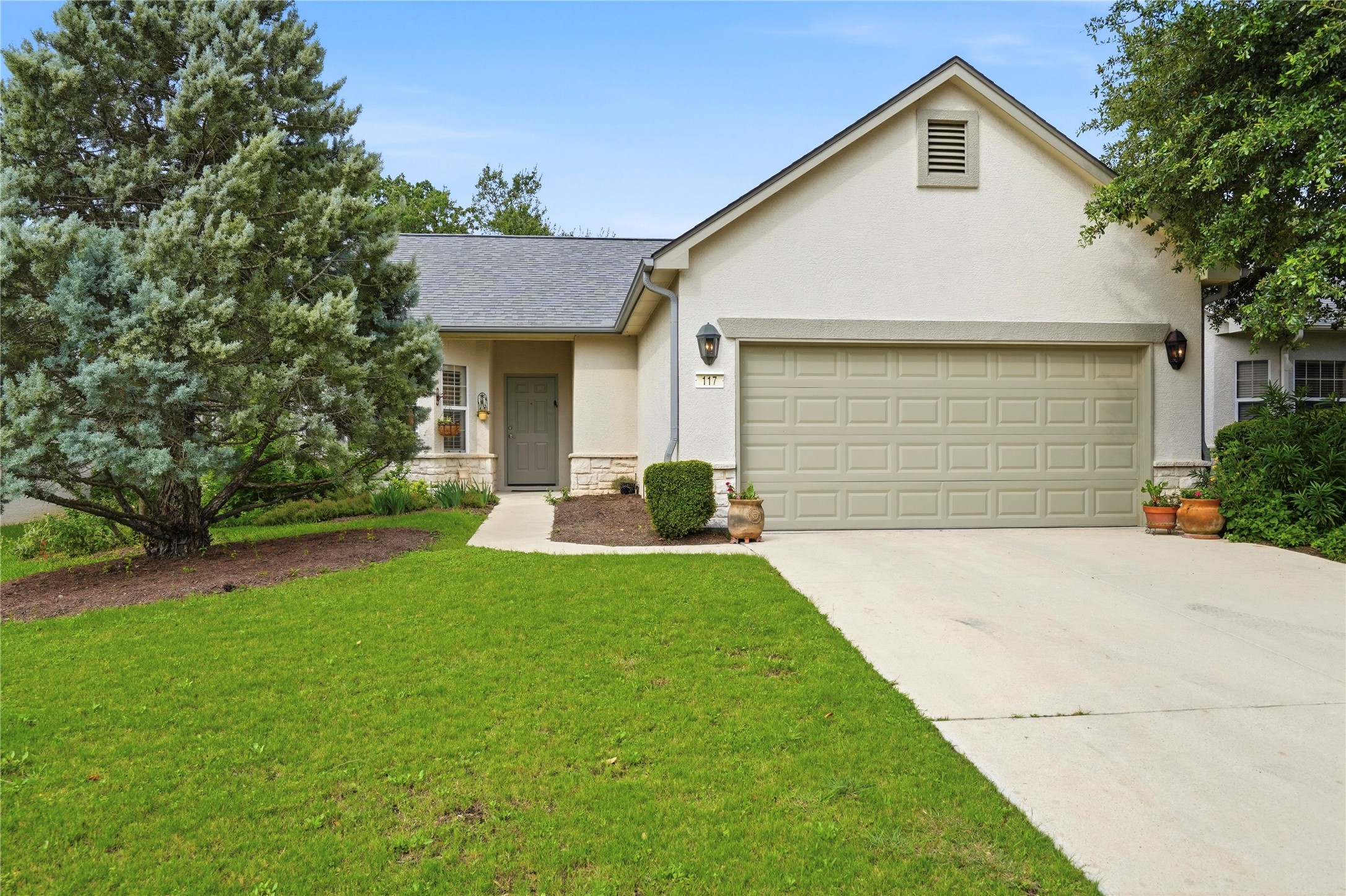 117 Whitewing Way Georgetown, TX 78633 - Photo 2 of 27 A welcoming front yard with a well-maintained lawn and an attached 2 car garage