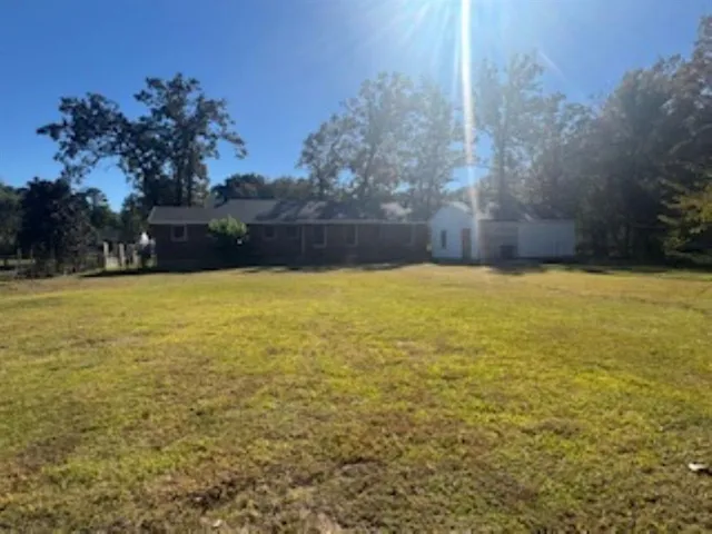 a view of empty pool with trees in the background