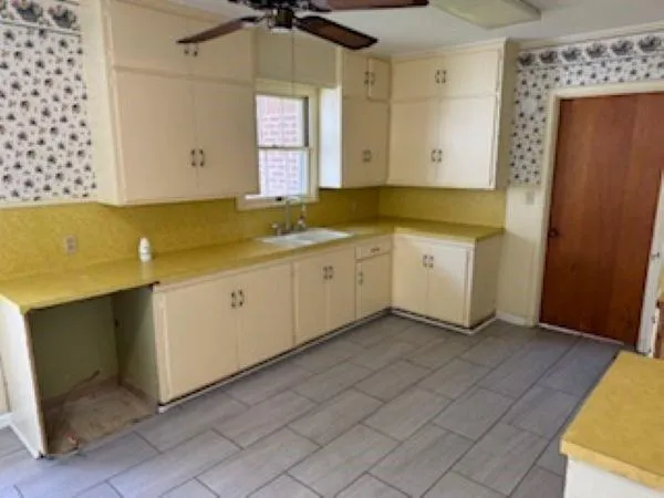 a room with a sink cabinets and utility room