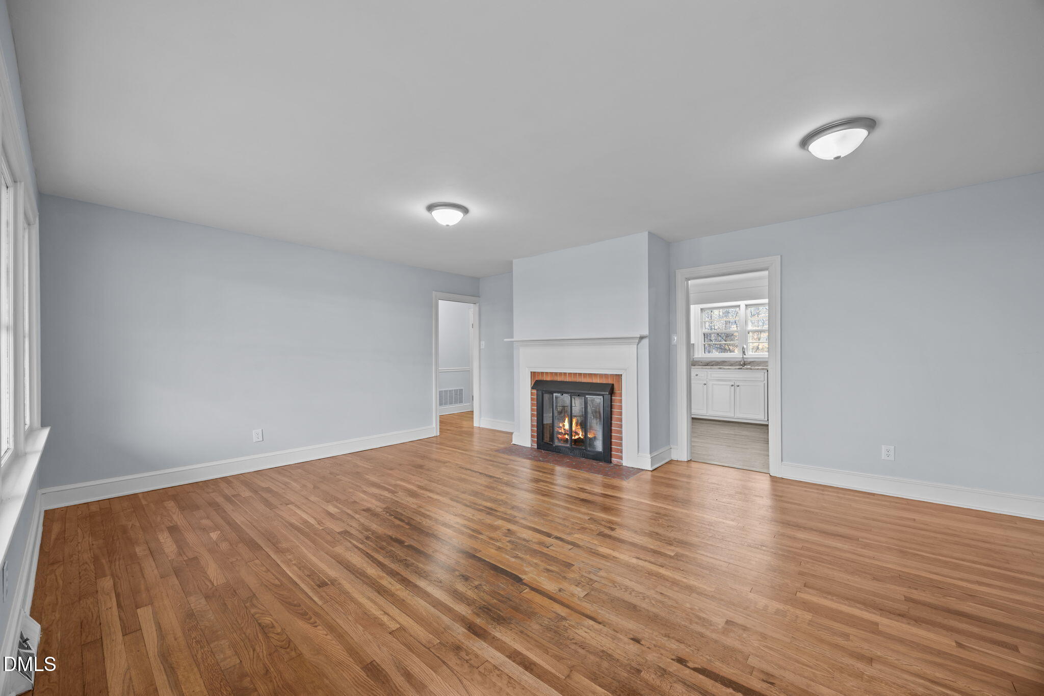 122 Ridgecrest Drive Warrenton, NC 27589 - Photo 21 of 48 a view of an empty room with wooden floor fireplace and a window