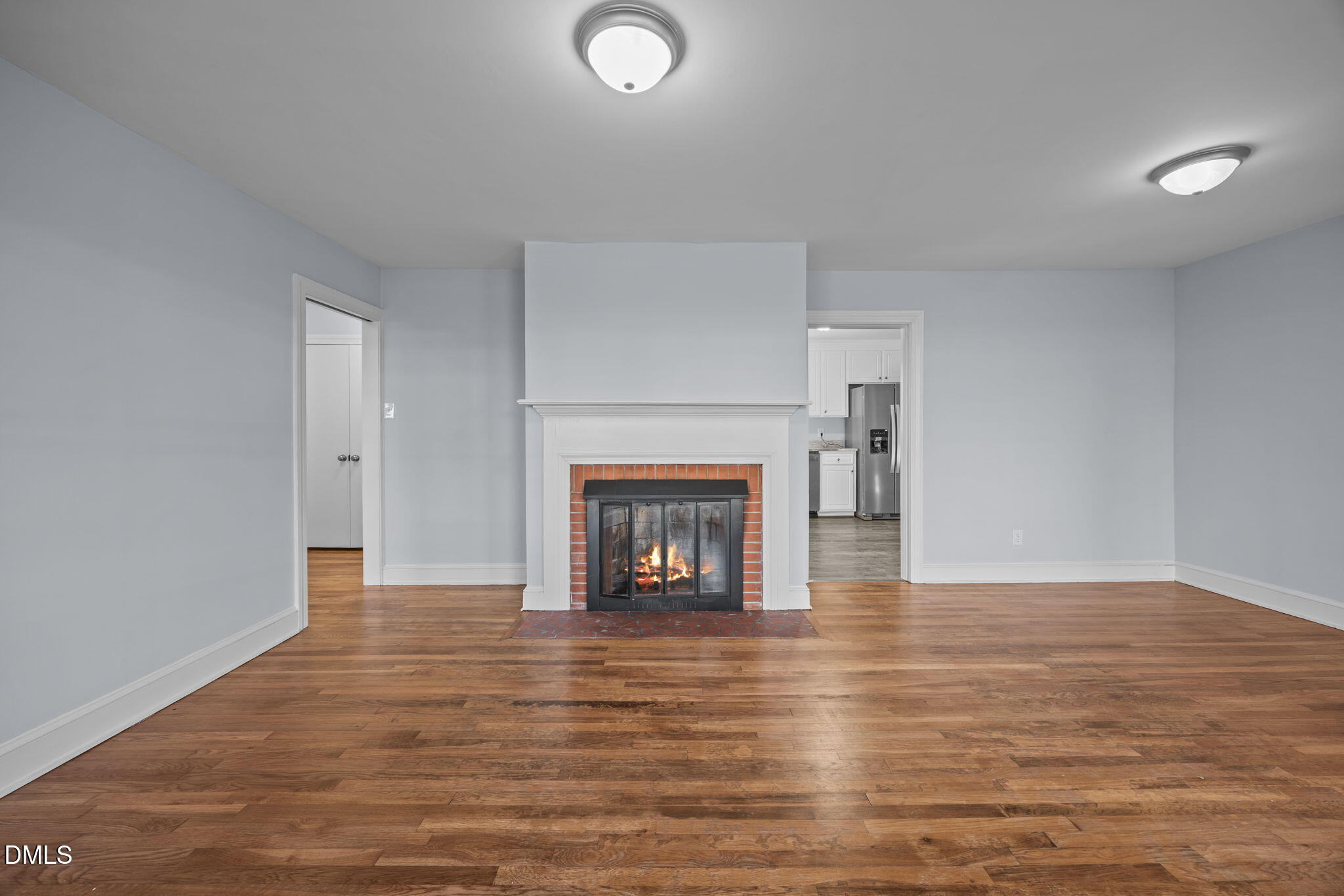 122 Ridgecrest Drive Warrenton, NC 27589 - Photo 22 of 48 a view of an empty room with wooden floor fireplace and a window