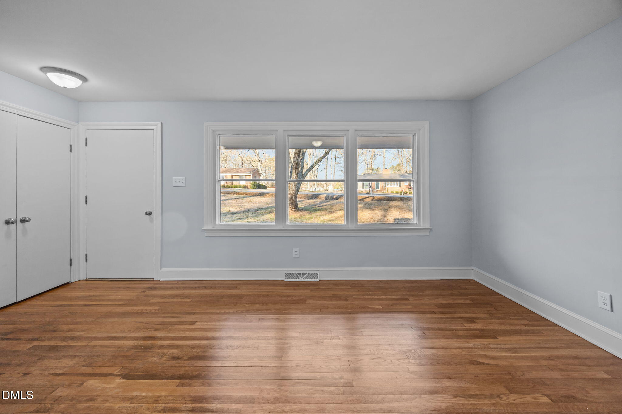122 Ridgecrest Drive Warrenton, NC 27589 - Photo 23 of 48 a view of an empty room with wooden floor and a window