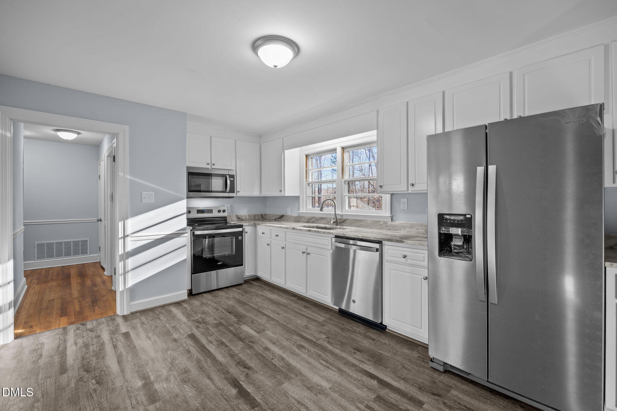 122 Ridgecrest Drive Warrenton, NC 27589 - Photo 29 of 48 a kitchen with white cabinets and stainless steel appliances