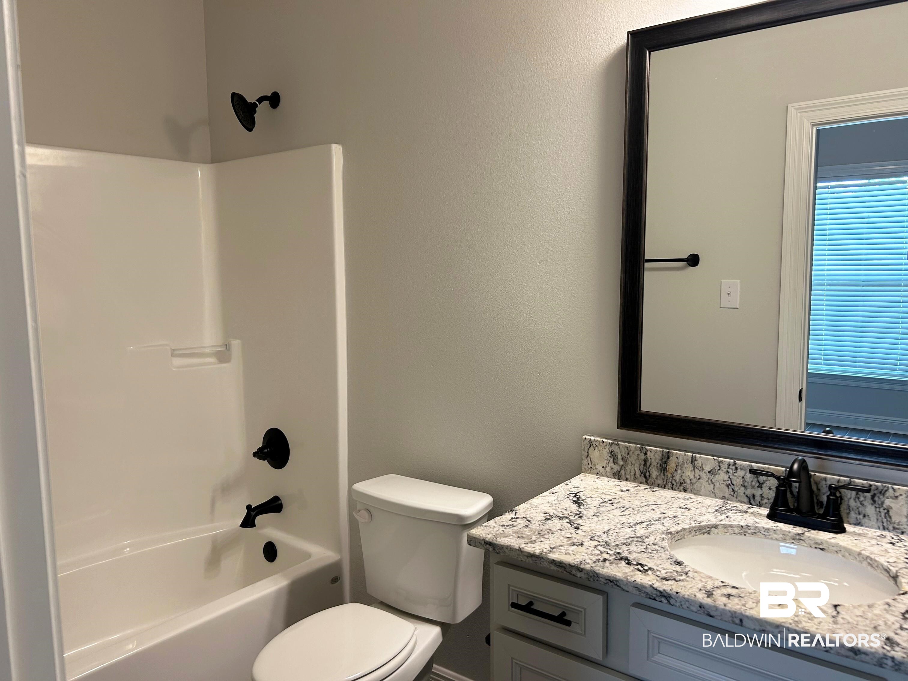 876 Sumter Loop Foley, AL 36535 - Photo 20 of 24 Full bathroom with shower combination, vanity, and toilet