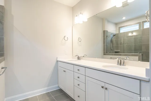 a bathroom with a double vanity sink and mirror
