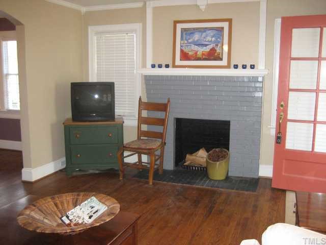 2709 Van Dyke Avenue Raleigh, NC 27607 - Photo 2 of 11 a living room with furniture and a fireplace