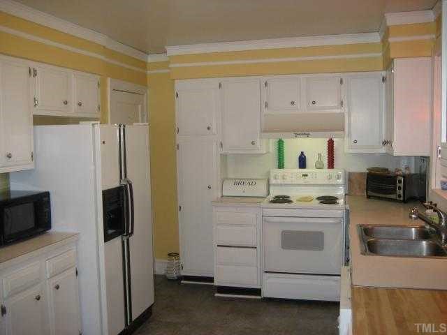 2709 Van Dyke Avenue Raleigh, NC 27607 - Photo 3 of 11 a kitchen with a sink a stove and refrigerator