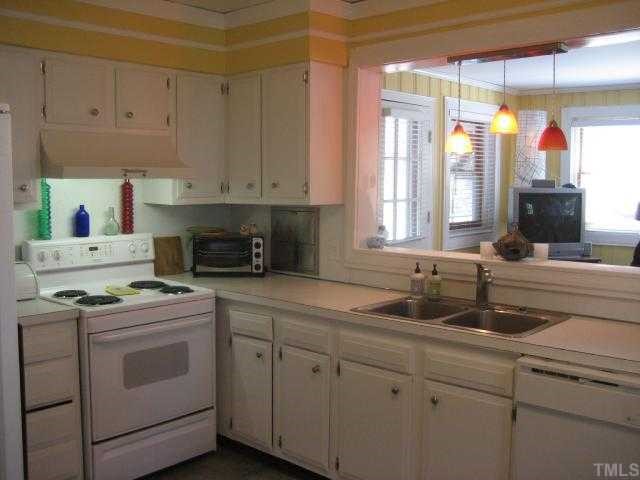 2709 Van Dyke Avenue Raleigh, NC 27607 - Photo 4 of 11 a kitchen with white cabinets and white appliances