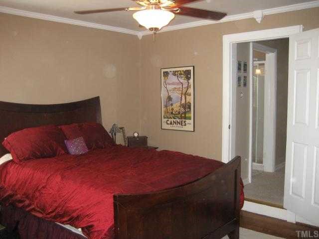 2709 Van Dyke Avenue Raleigh, NC 27607 - Photo 7 of 11 a bedroom with a bed and a chandelier