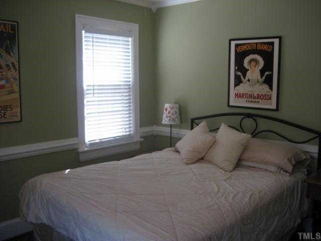 2709 Van Dyke Avenue Raleigh, NC 27607 - Photo 8 of 11 a bedroom with a bed and a window