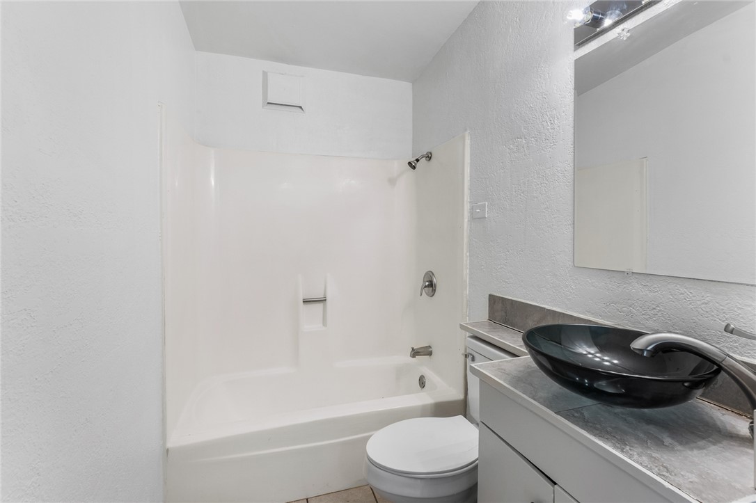 4917 Marion Circle Corpus Christi, TX 78411 - Photo 11 of 14 a bathroom with a toilet and a bathtub