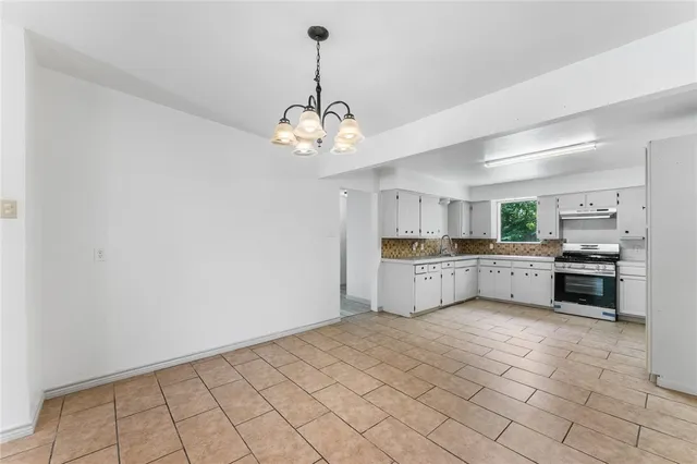 a view of a kitchen with a sink and cabinets