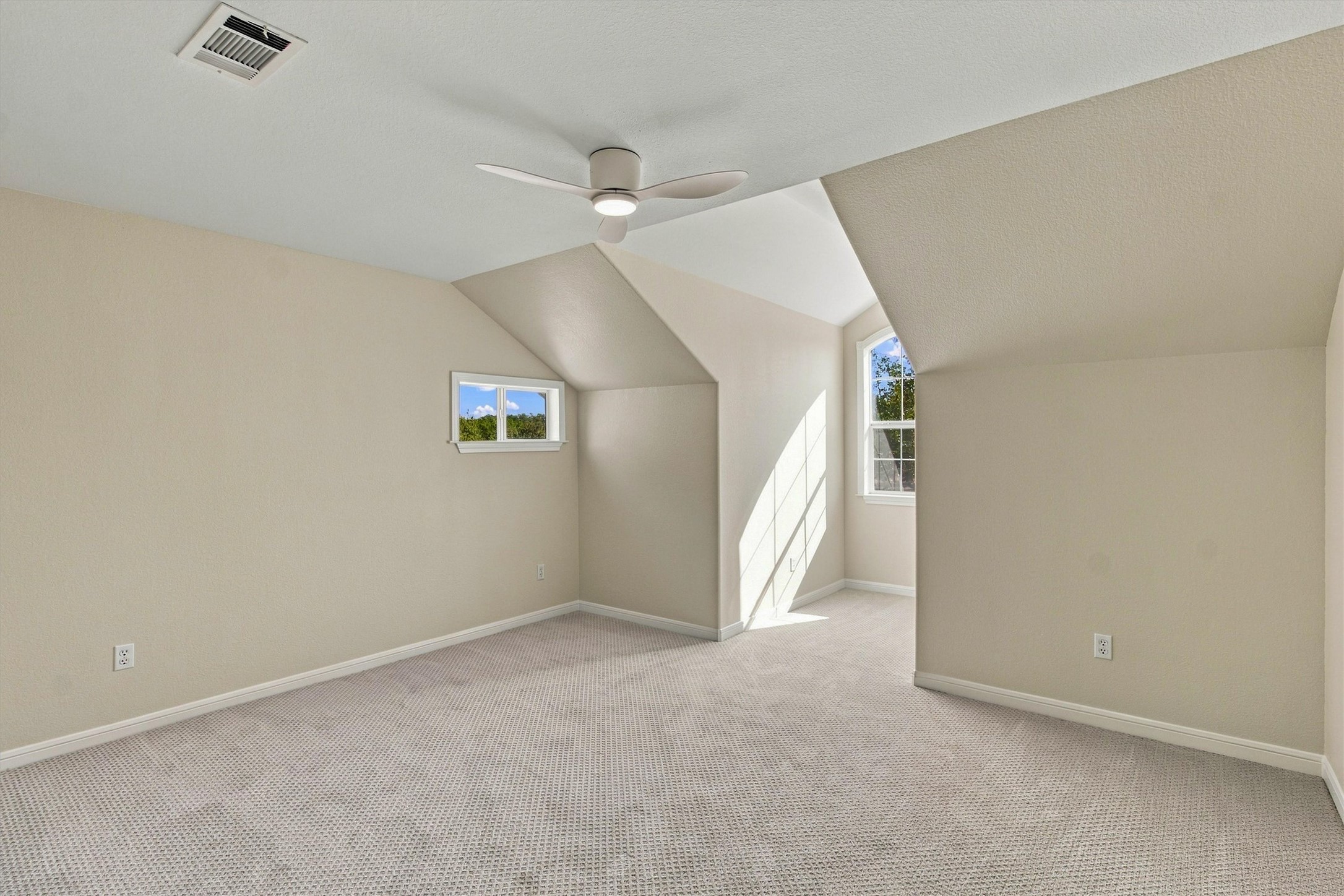 1651 Old Red Ranch Road Dripping Springs, TX 78620 - Photo 19 of 31 Angled ceilings and soft carpeting create a cozy atmosphere in this upstairs bedroom.