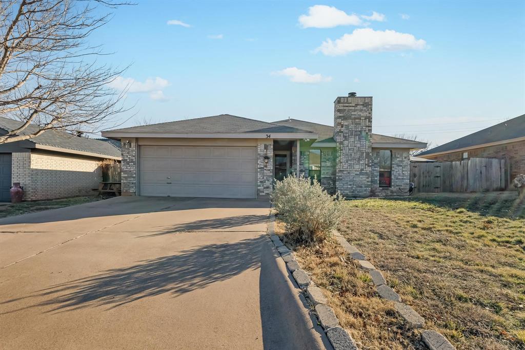 View of front of home featuring a garage and a front yard