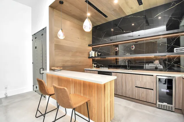 a living room with furniture and floor to ceiling windows