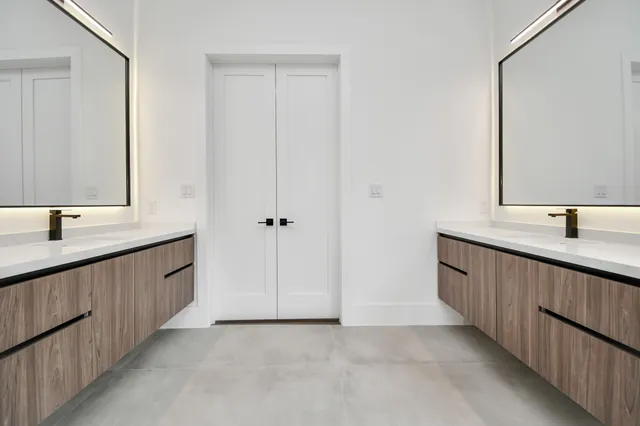 a view of an empty room with wooden floor and a cabinet