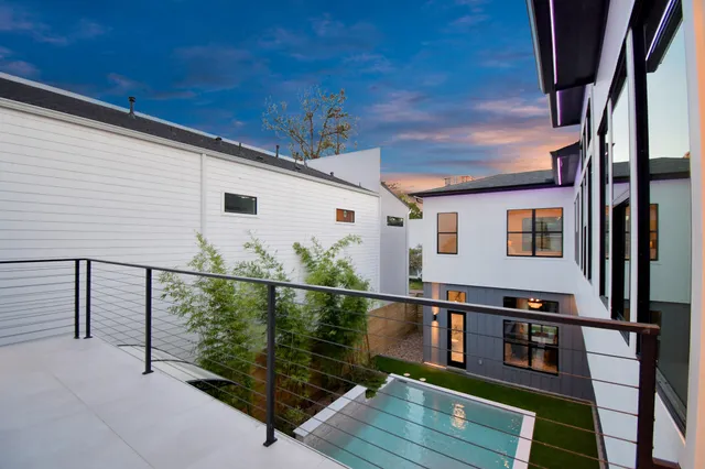 a view of a balcony with potted plants
