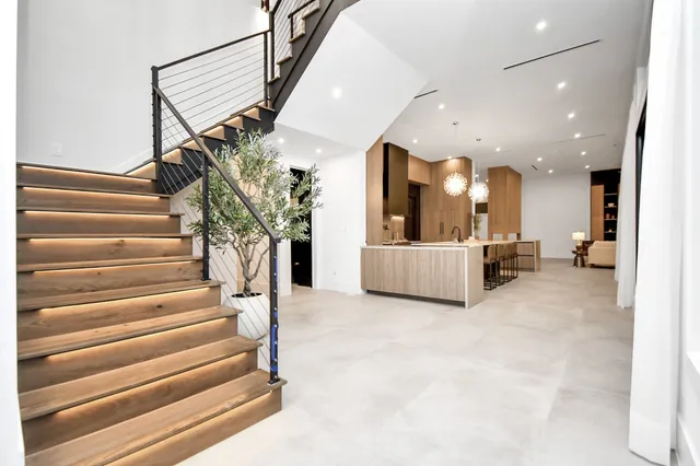 a view of a hallway with wooden floor and entryway