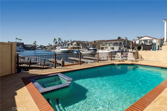 a view of a swimming pool with lawn chairs
