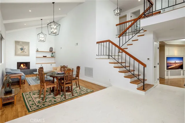 a view of a dining room with furniture wooden floor and a chandelier