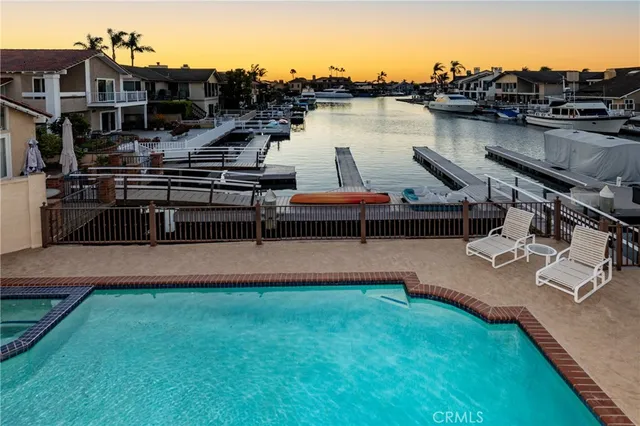 a view of a lake with boats and palm trees