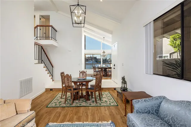 a living room with furniture and a dining table
