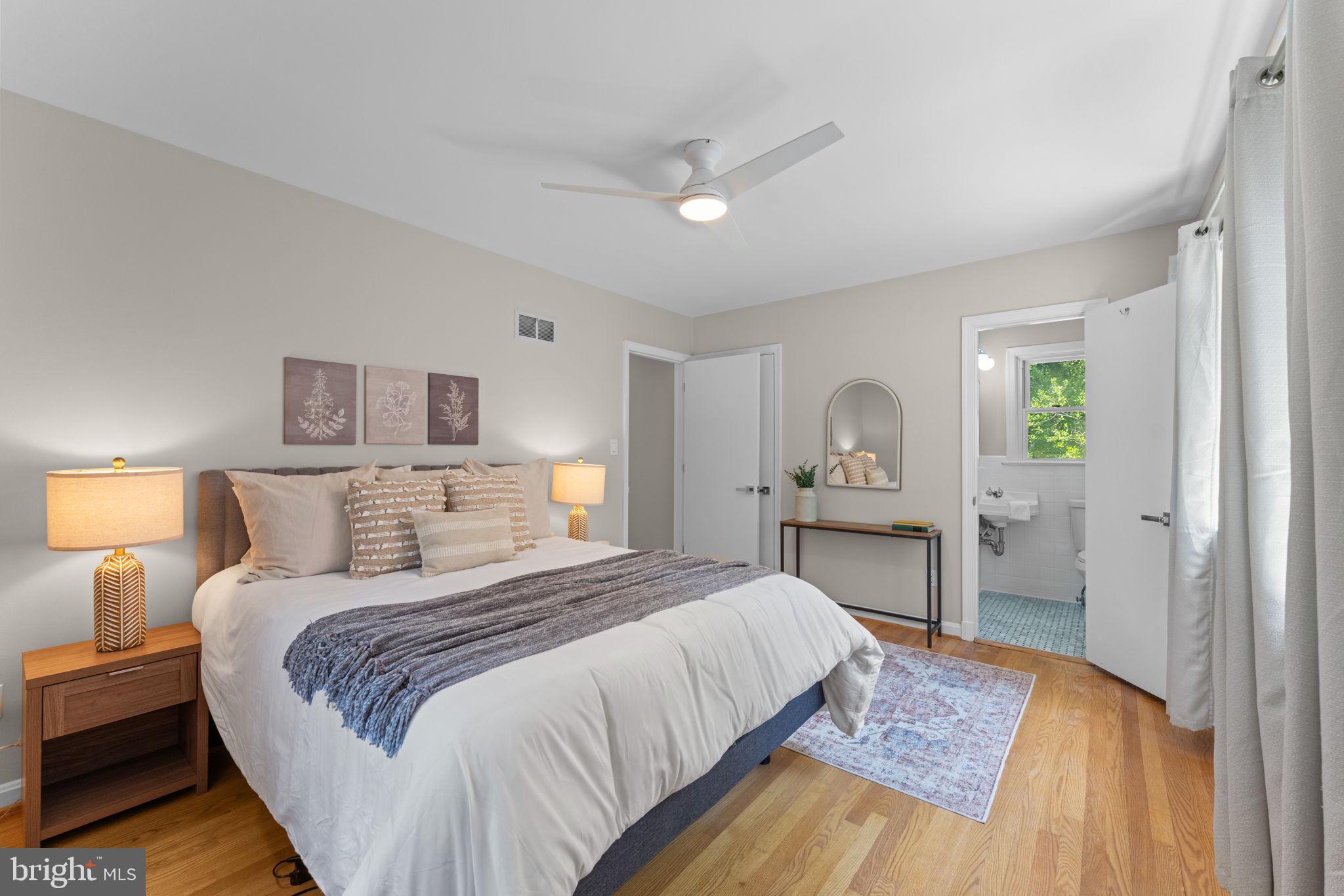 11712 Berwick Road Silver Spring, MD 20904 - Photo 12 of 42 a bedroom with a bed and a lamp