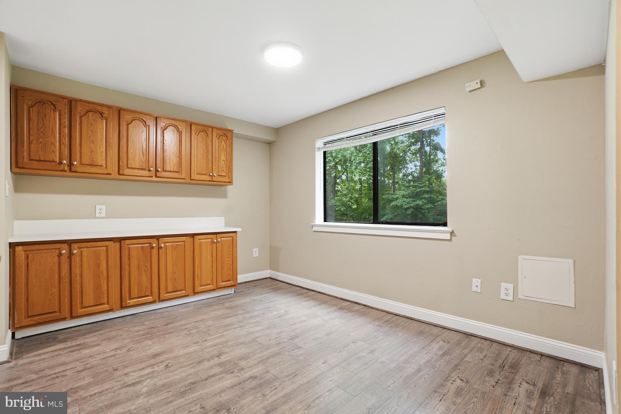 8487 Greenbelt Road Greenbelt, MD 20770 - Photo 7 of 29 an empty room with wooden floor and windows