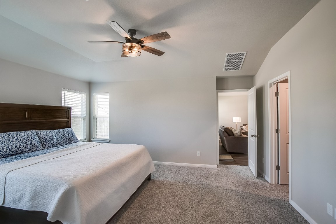 403 Grapefruit Road Hutto, TX 78634 - Photo 18 of 30 a bedroom with a bed and a chandelier