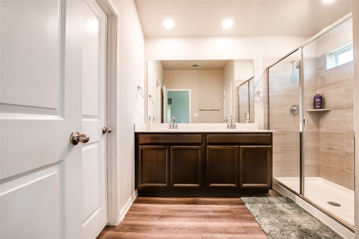 403 Grapefruit Road Hutto, TX 78634 - Photo 20 of 30 a bathroom with a sink a mirror and a shower