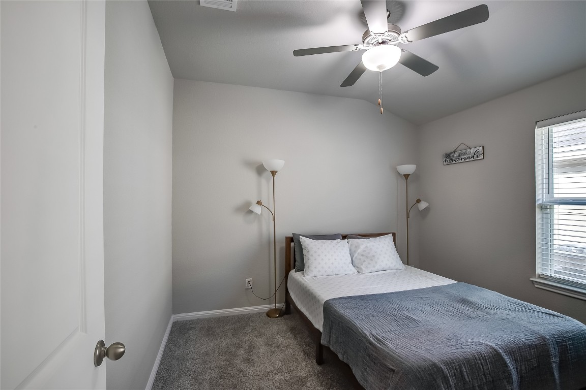 403 Grapefruit Road Hutto, TX 78634 - Photo 21 of 30 a bedroom with a bed and a window