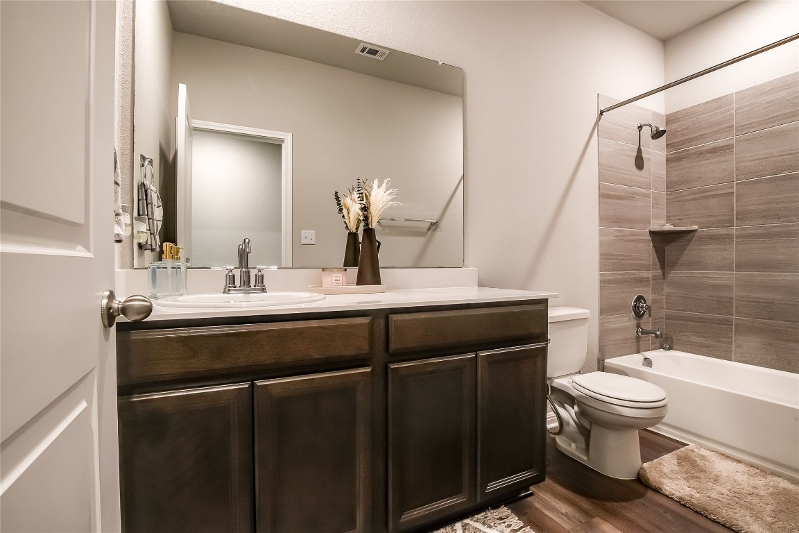 403 Grapefruit Road Hutto, TX 78634 - Photo 22 of 30 a bathroom with a sink a toilet and shower