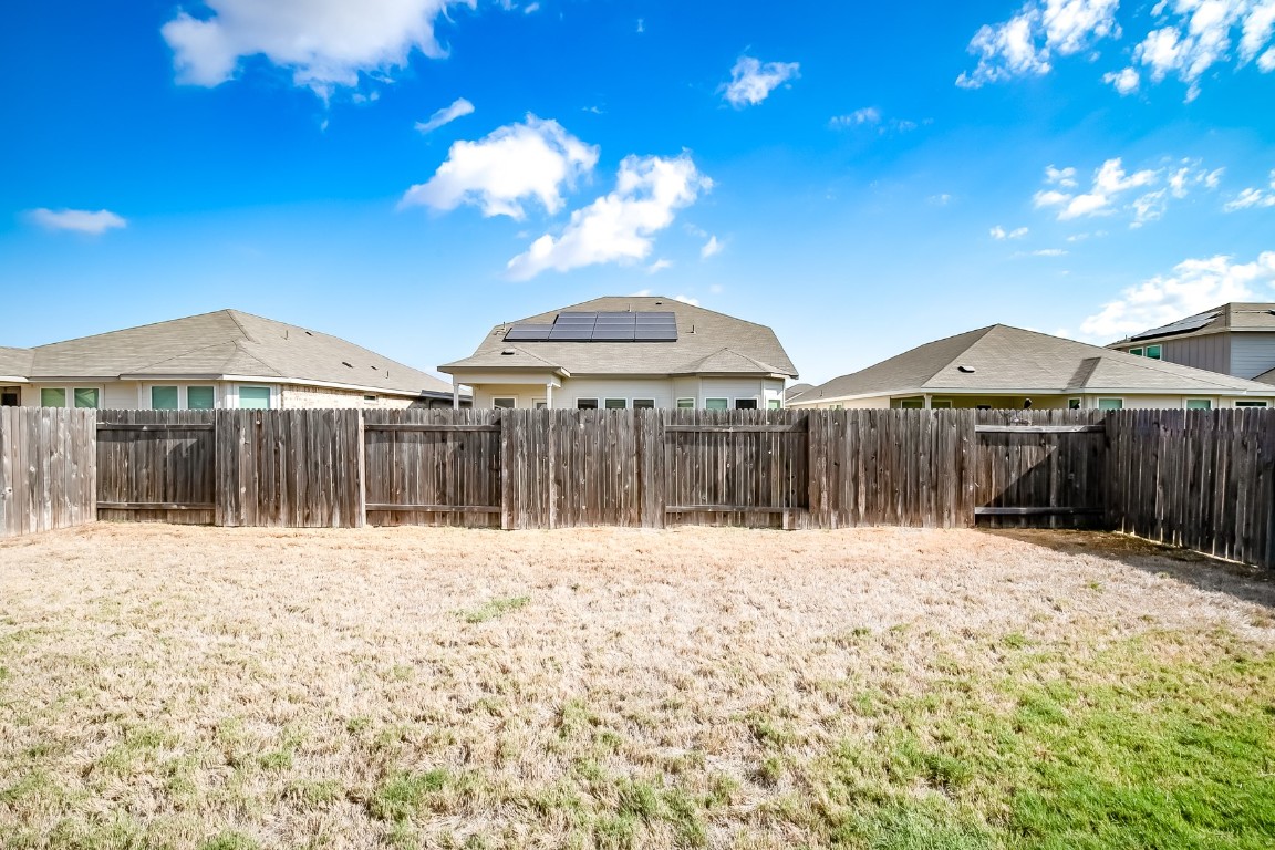 403 Grapefruit Road Hutto, TX 78634 - Photo 25 of 30 a view of backyard with a barbeque grill and a yard