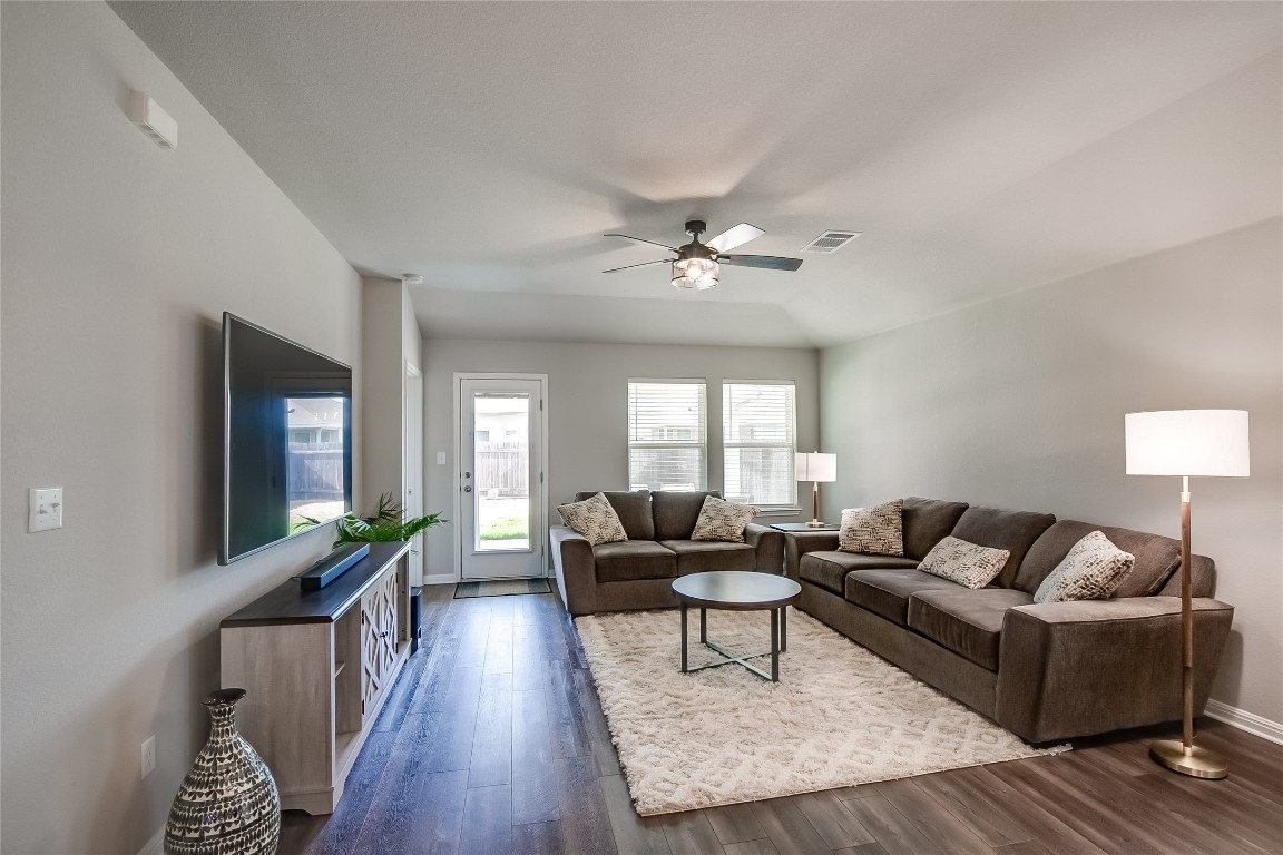 403 Grapefruit Road Hutto, TX 78634 - Photo 6 of 30 a living room with furniture and wooden floor