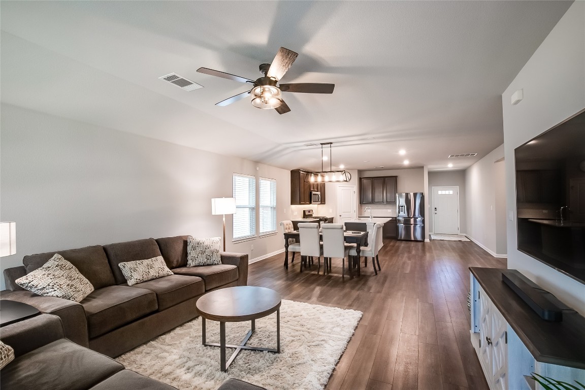 403 Grapefruit Road Hutto, TX 78634 - Photo 8 of 30 a living room with furniture a rug and a flat screen tv