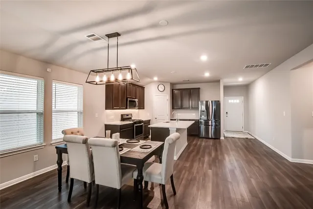 a view of a dining room with furniture window and wooden floor