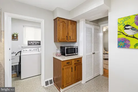 a kitchen with a stove top oven and refrigerator