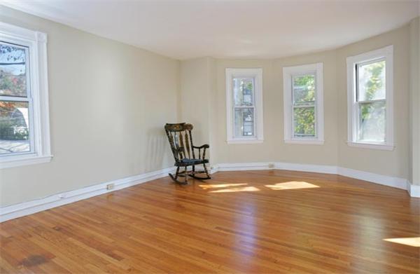 179 High Street, Unit 2 Brookline, MA 02445 - Photo 2 of 5 a view of empty room with wooden floor and fan