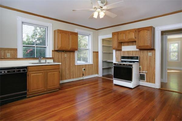 179 High Street, Unit 2 Brookline, MA 02445 - Photo 3 of 5 a kitchen with stainless steel appliances granite countertop a stove a sink and a refrigerator