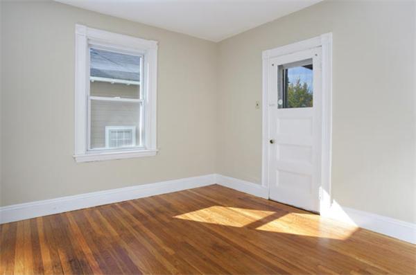 179 High Street, Unit 2 Brookline, MA 02445 - Photo 4 of 5 a view of empty room with wooden floor and fan