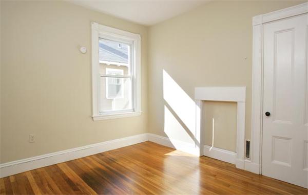 179 High Street, Unit 2 Brookline, MA 02445 - Photo 5 of 5 a view of an empty room with wooden floor and a window