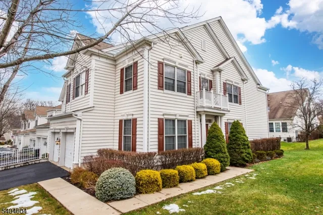 a view of a white house with a yard and couches chairs and a fire pit