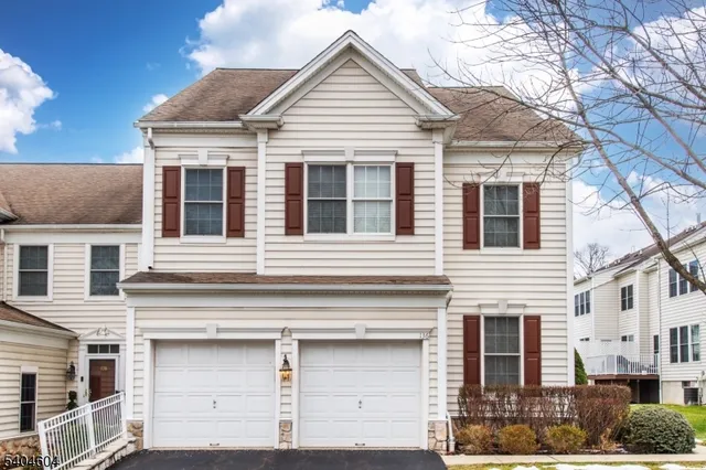 a view of a white house with large windows