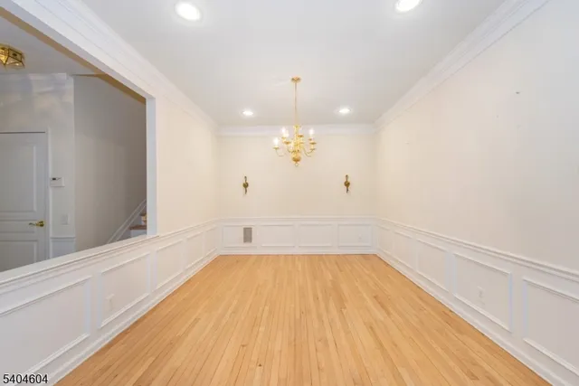 a view of a room with wooden floor and ceiling fan