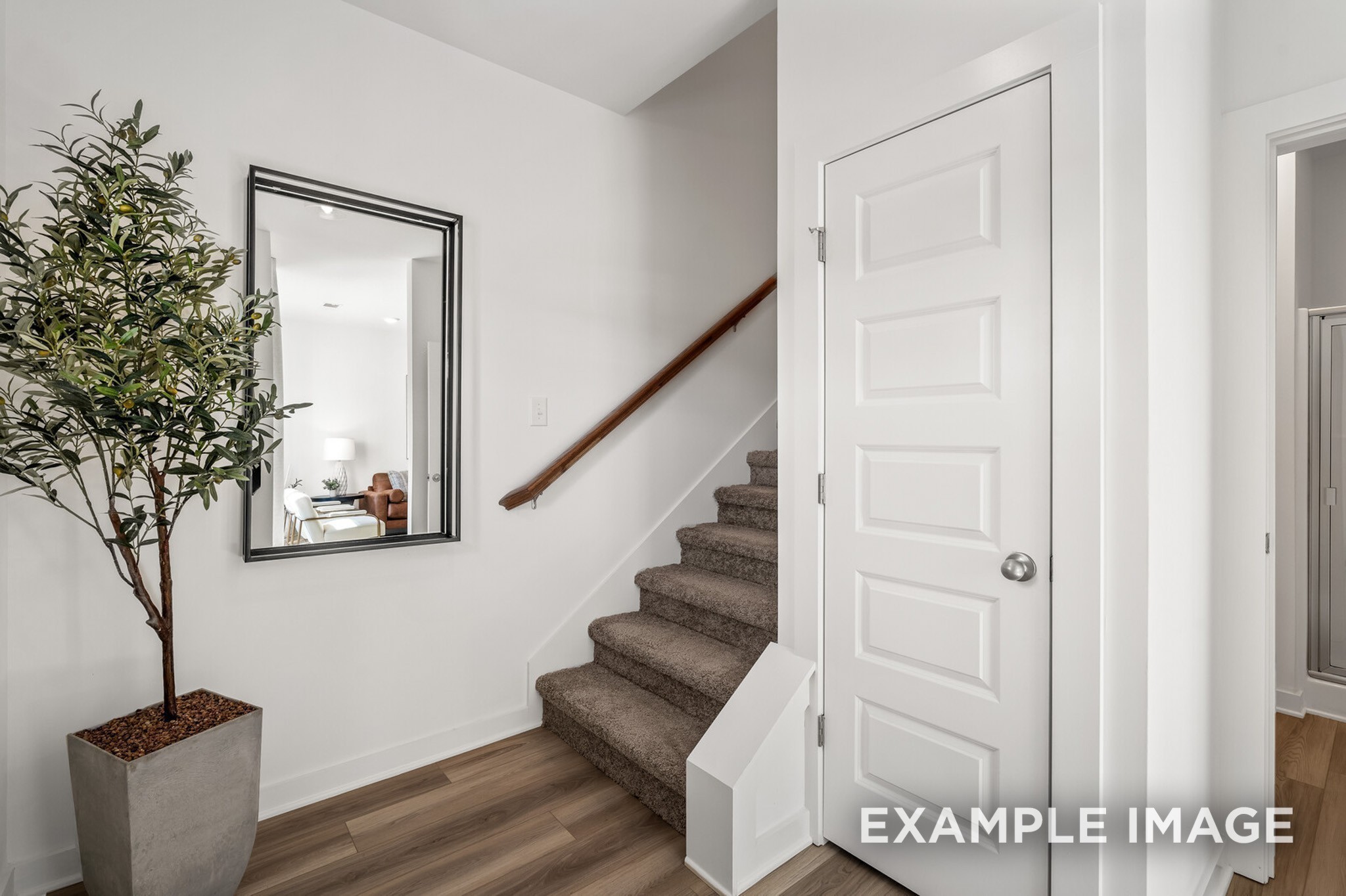1721 Elliott Williams Way Gallatin, TN 37066 - Photo 8 of 22 a view of staircase with wooden floor and a potted plant