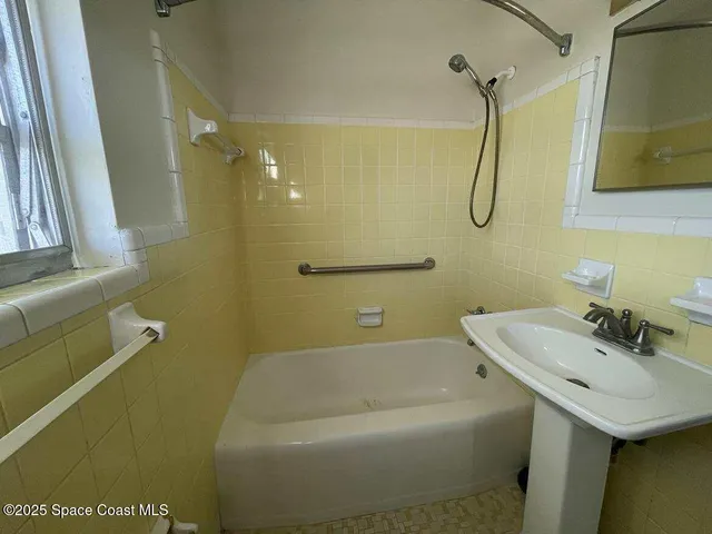 a bathroom with a sink a mirror toilet and bathtub